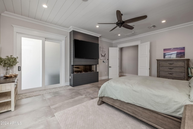 bedroom featuring ceiling fan, a large fireplace, and ornamental molding