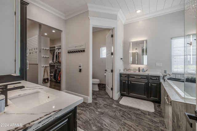 bathroom featuring a tub to relax in, toilet, vanity, and ornamental molding