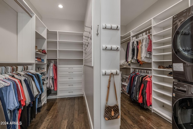 spacious closet featuring dark hardwood / wood-style floors and stacked washer and clothes dryer