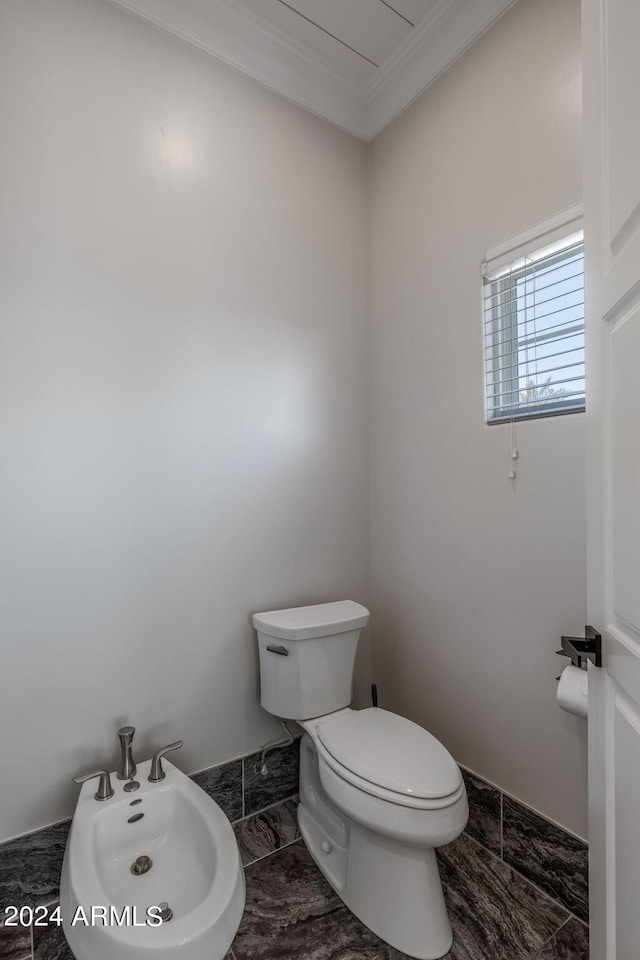 bathroom with a bidet, ornamental molding, and toilet