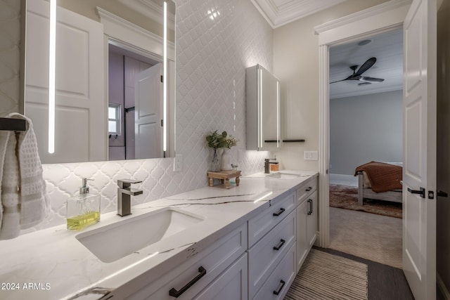 bathroom featuring vanity, decorative backsplash, and ornamental molding