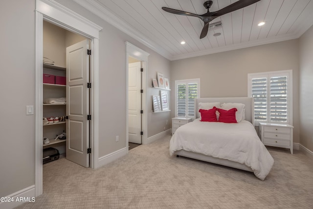 bedroom with ceiling fan, light carpet, and ornamental molding