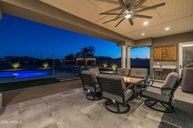 patio terrace at dusk with a gazebo and ceiling fan