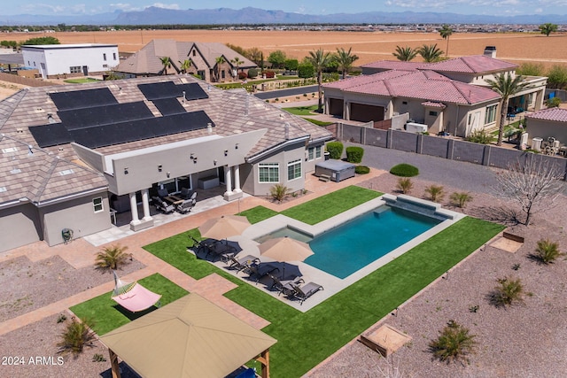 view of swimming pool with a mountain view and a patio area