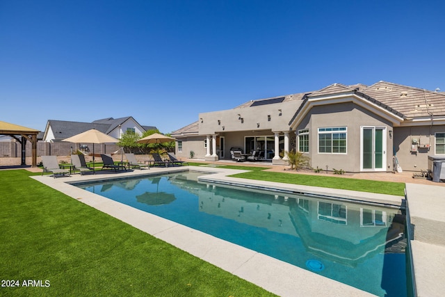 view of swimming pool with a lawn and a patio