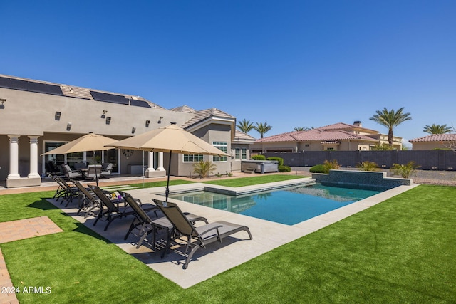 view of swimming pool with a patio area, a jacuzzi, and a yard