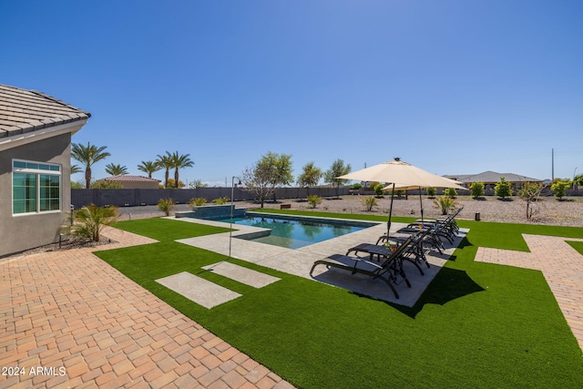 view of pool featuring a lawn and a patio area