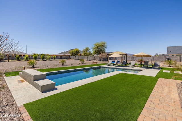 view of swimming pool with a patio and a lawn