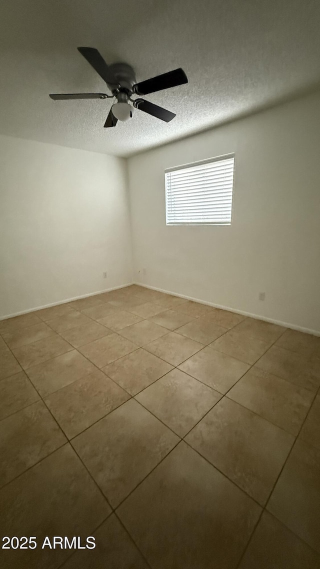 4217 W Medlock Dr, Phoenix, AZ 85019 - unfurnished room featuring tile patterned flooring, ceiling fan, and a textured ceiling