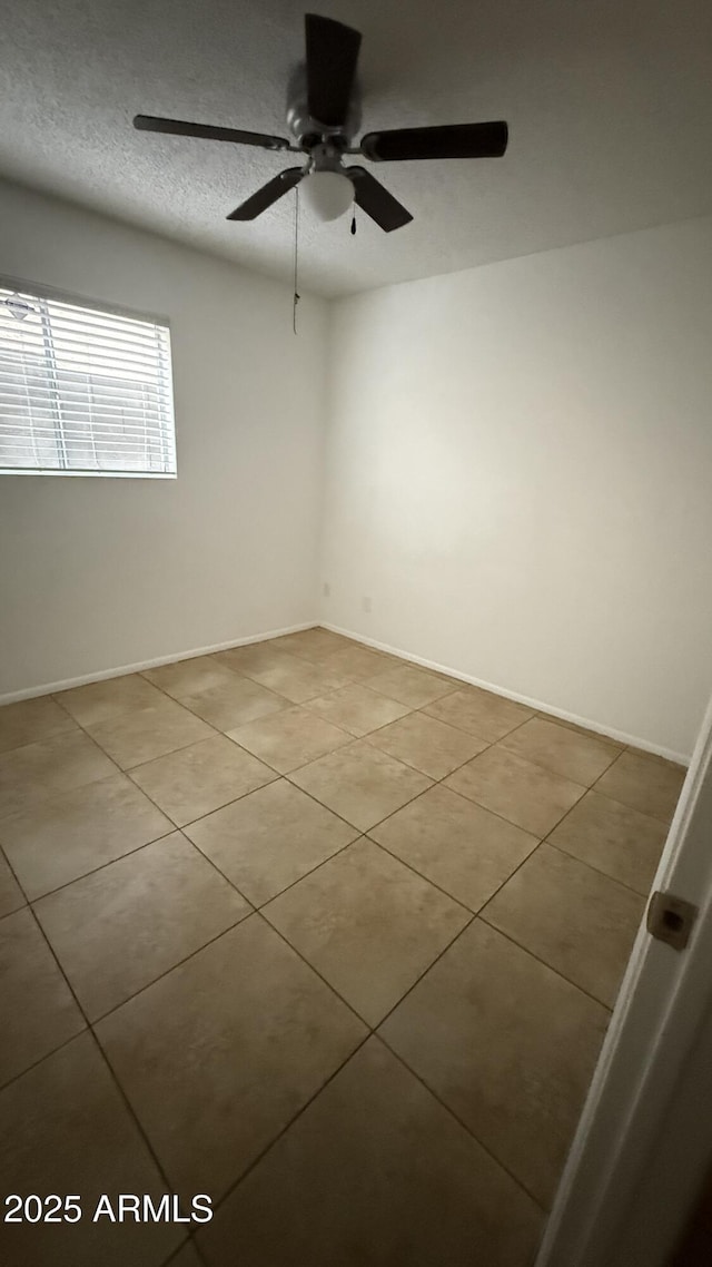 4217 W Medlock Dr, Phoenix, AZ 85019 - empty room featuring light tile patterned floors and a ceiling fan