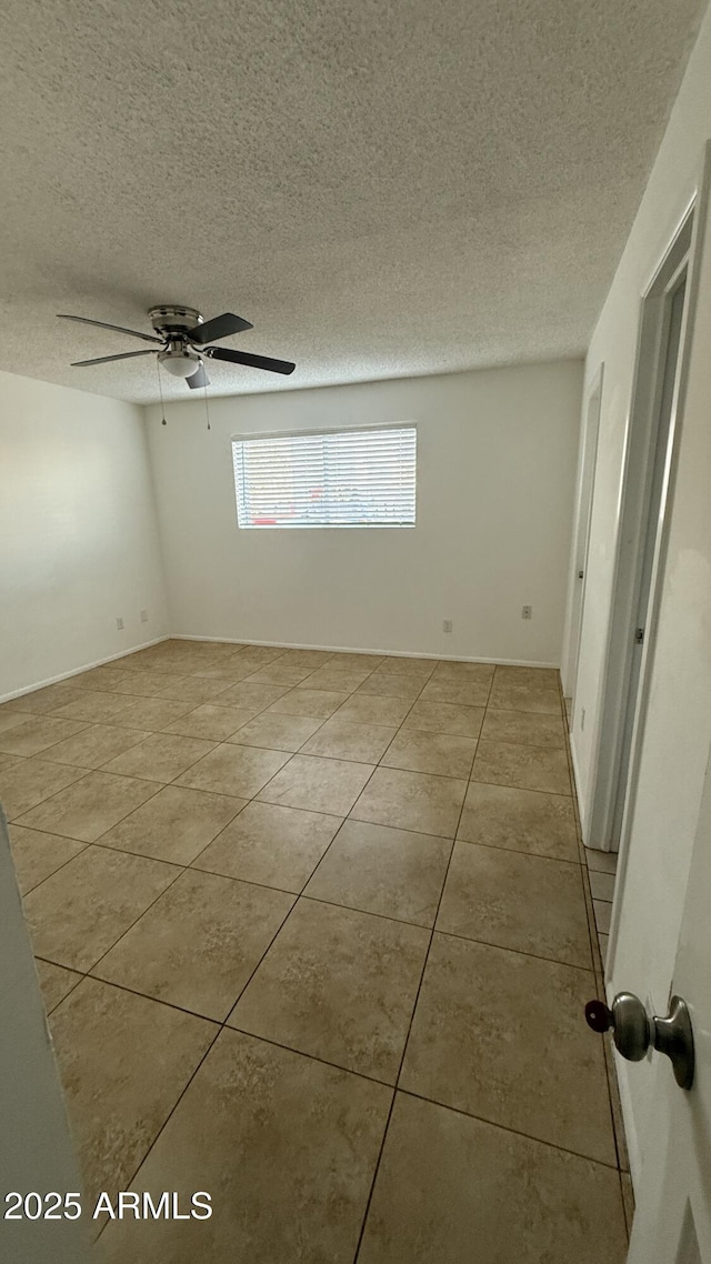 4217 W Medlock Dr, Phoenix, AZ 85019 - spare room with tile patterned flooring, a textured ceiling, and ceiling fan