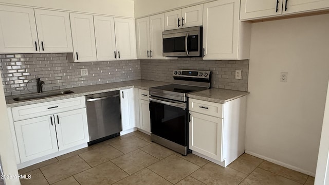 4217 W Medlock Dr, Phoenix, AZ 85019 - kitchen featuring stainless steel appliances, tasteful backsplash, light tile patterned floors, and white cabinetry