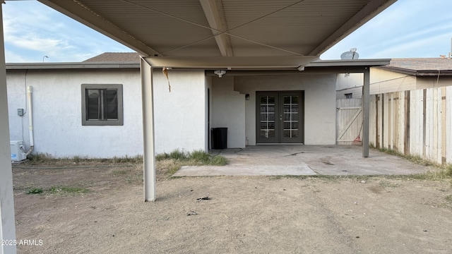 4217 W Medlock Dr, Phoenix, AZ 85019 - doorway to property with french doors, stucco siding, and a patio