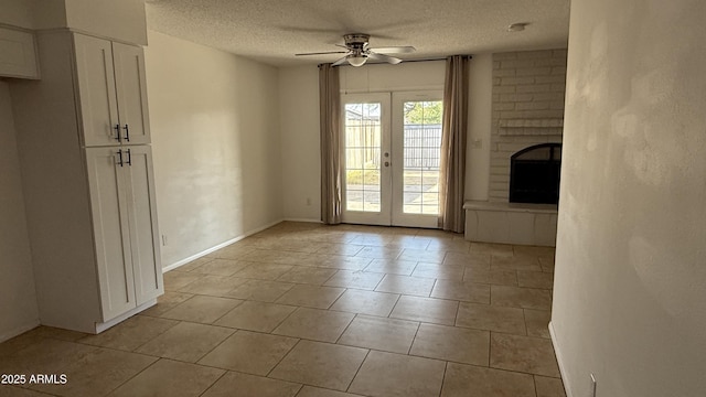 4217 W Medlock Dr, Phoenix, AZ 85019 - unfurnished living room with a ceiling fan, a textured ceiling, a brick fireplace, light tile patterned floors, and french doors