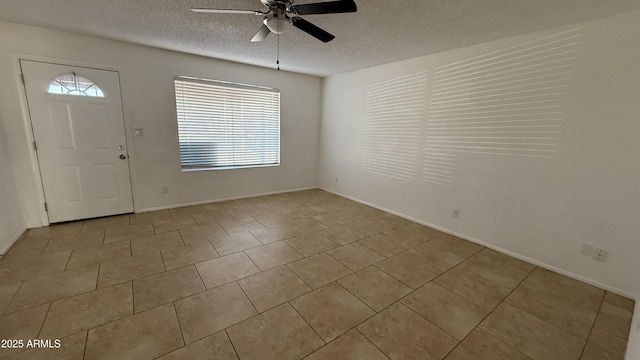4217 W Medlock Dr, Phoenix, AZ 85019 - tiled entryway featuring a ceiling fan, healthy amount of natural light, and a textured ceiling