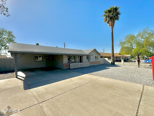 ranch-style home featuring a carport