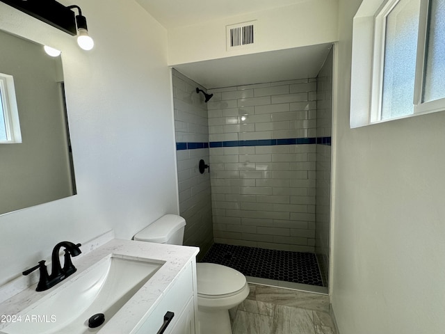 3637 W Myrtle Ave, Phoenix, AZ 85051 - full bathroom featuring toilet, marble finish floors, tiled shower, and plenty of natural light