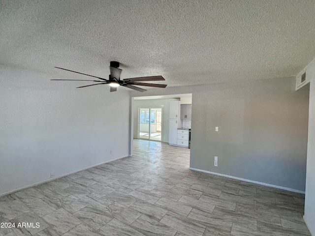 spare room featuring a textured ceiling and ceiling fan