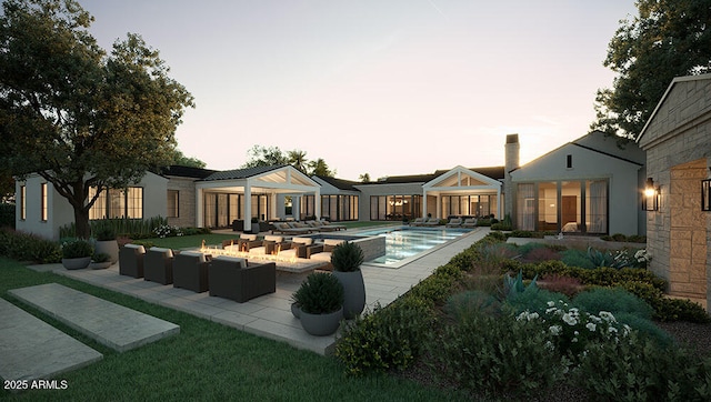 pool at dusk featuring a patio and outdoor lounge area