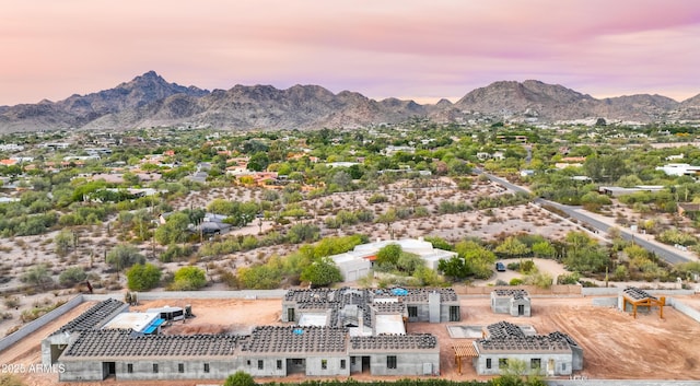 aerial view at dusk featuring a mountain view