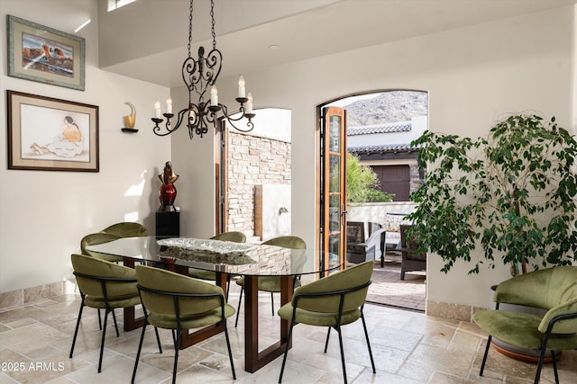 6102 E Sage Dr, Paradise Valley, AZ 85253 - dining area featuring stone tile flooring and a chandelier