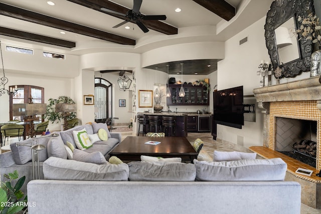6102 E Sage Dr, Paradise Valley, AZ 85253 - living room with a chandelier, arched walkways, beam ceiling, bar with sink, and recessed lighting