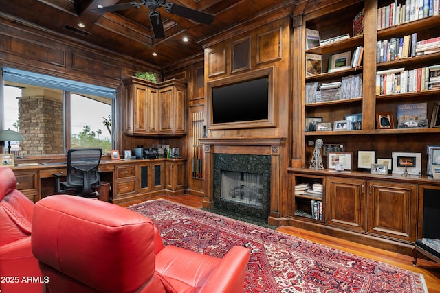 6102 E Sage Dr, Paradise Valley, AZ 85253 - home office with wood ceiling with exposed beams, wood walls, a ceiling fan, built in desk, and wood finished floors