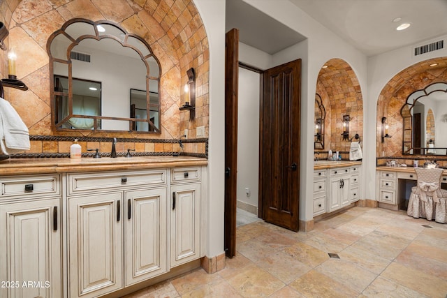 6102 E Sage Dr, Paradise Valley, AZ 85253 - full bath featuring decorative backsplash, two vanities, baseboards, stone tile floors, and recessed lighting