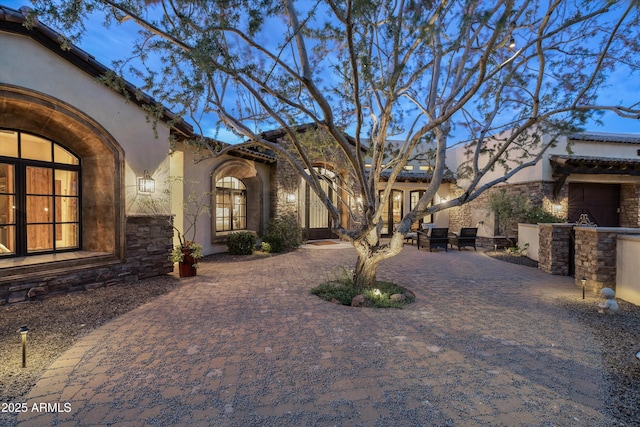6102 E Sage Dr, Paradise Valley, AZ 85253 - view of front of property with stucco siding, stone siding, and a patio area