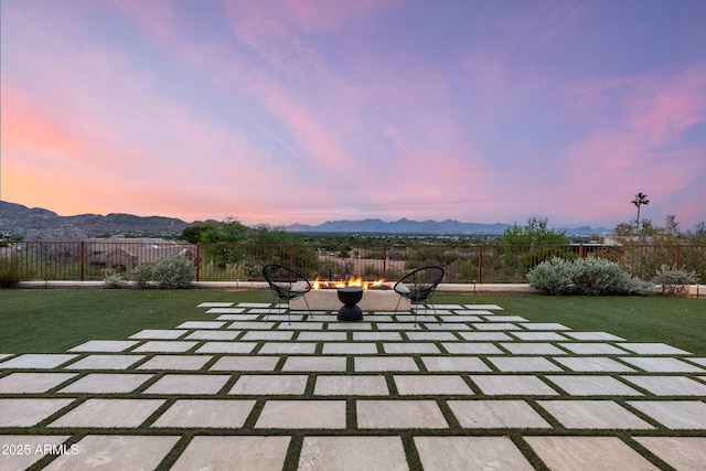 6102 E Sage Dr, Paradise Valley, AZ 85253 - patio terrace at dusk with a fire pit, a mountain view, and a patio