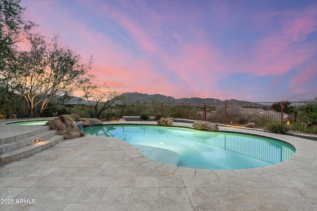 6102 E Sage Dr, Paradise Valley, AZ 85253 - pool at dusk with an in-ground hot tub, a fenced backyard, and a patio