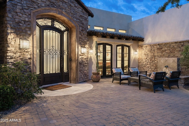 6102 E Sage Dr, Paradise Valley, AZ 85253 - view of exterior entry with french doors, stone siding, and stucco siding