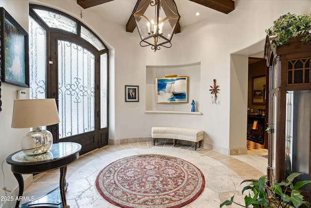 6102 E Sage Dr, Paradise Valley, AZ 85253 - foyer featuring stone tile flooring, inlaid floor details, beamed ceiling, healthy amount of natural light, and a chandelier
