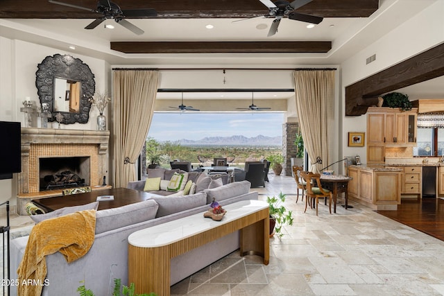 6102 E Sage Dr, Paradise Valley, AZ 85253 - living area with ceiling fan, a tray ceiling, stone tile flooring, and recessed lighting