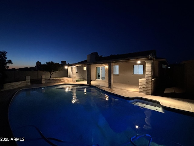 pool at night with a patio