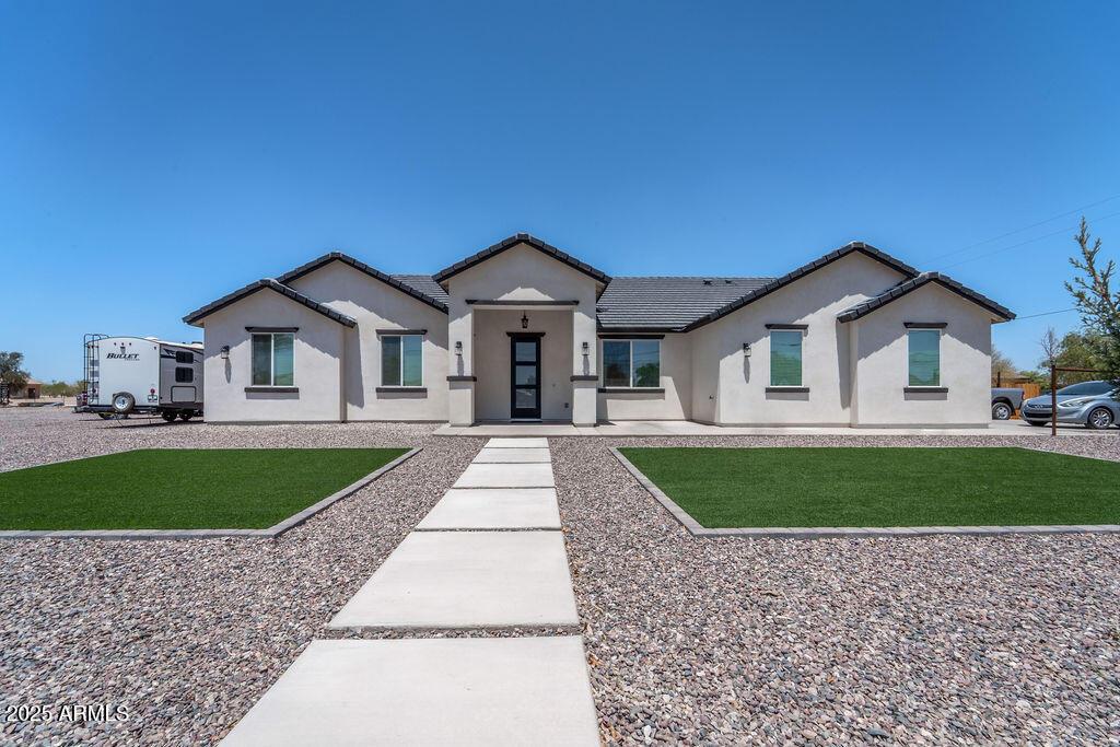 2706 S 336th Ave, Tonopah, AZ 85354 - view of front of home with stucco siding, a front lawn, and a tiled roof