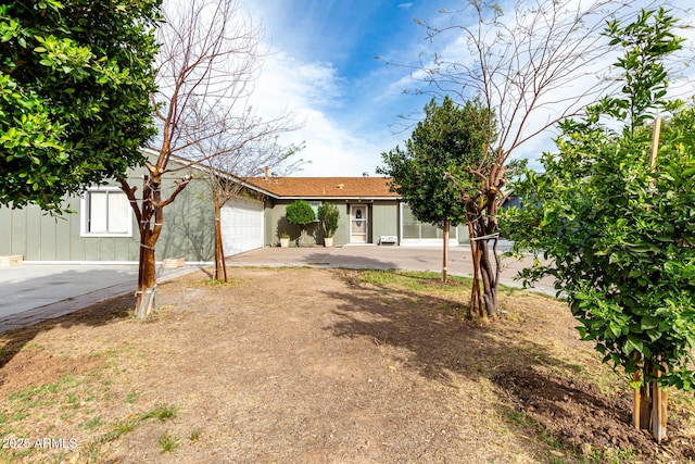 single story home featuring an attached garage and concrete driveway