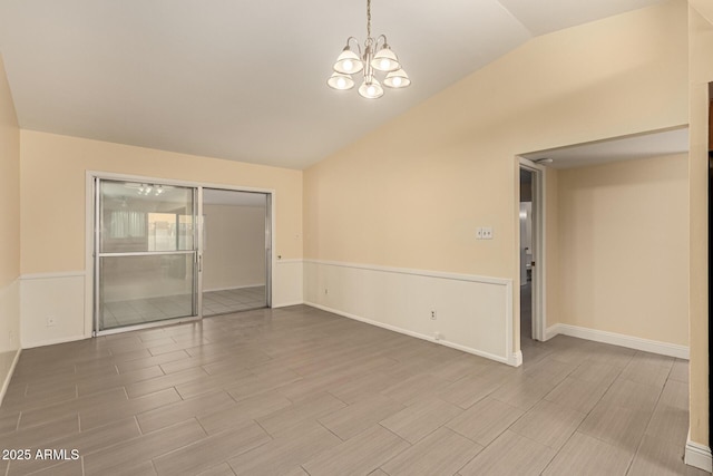 spare room with wood tiled floor, baseboards, vaulted ceiling, and a notable chandelier