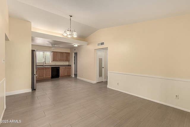 unfurnished living room featuring lofted ceiling, visible vents, wood finished floors, baseboards, and ceiling fan with notable chandelier