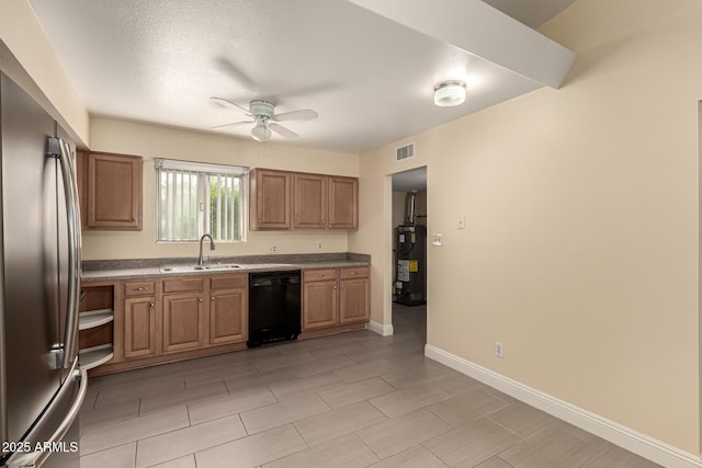 kitchen with electric water heater, a sink, visible vents, stainless steel refrigerator, and dishwasher