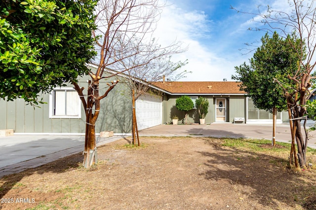 ranch-style house with a garage and driveway