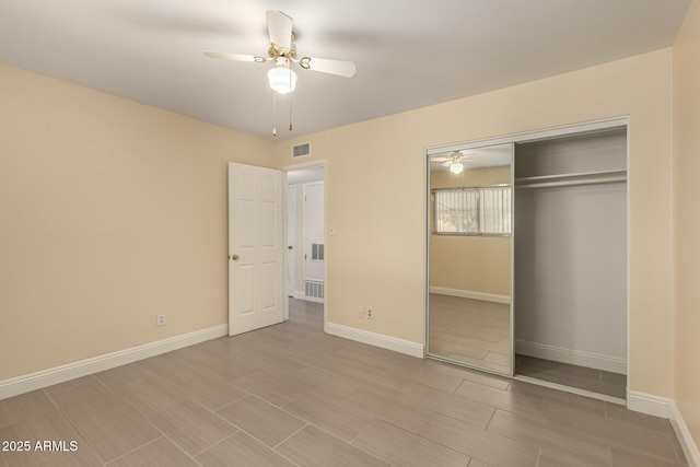 unfurnished bedroom with a closet, visible vents, ceiling fan, and baseboards