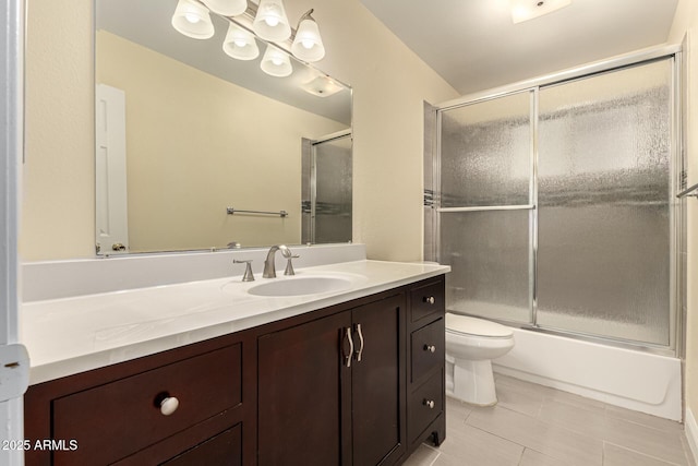 full bath with a chandelier, tile patterned flooring, toilet, shower / bath combination with glass door, and vanity