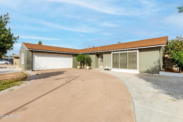 single story home with a garage and concrete driveway