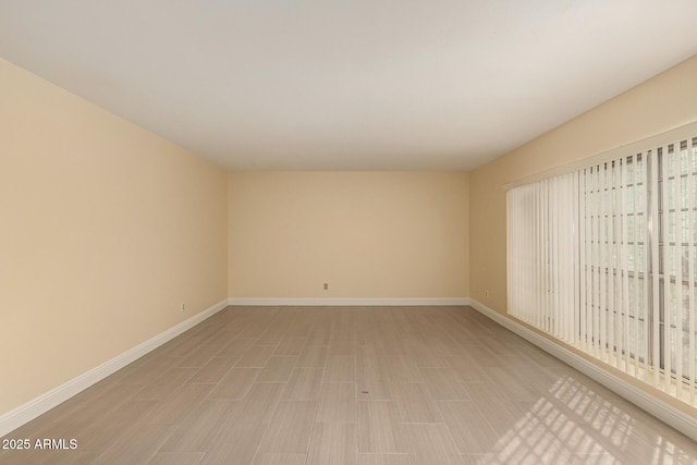 unfurnished room featuring light wood-style floors and baseboards