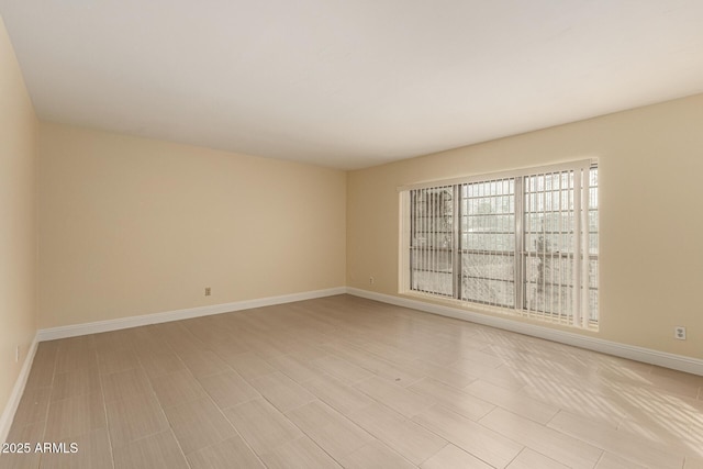 empty room featuring baseboards