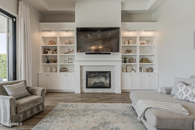 living area with dark wood-style flooring and a fireplace