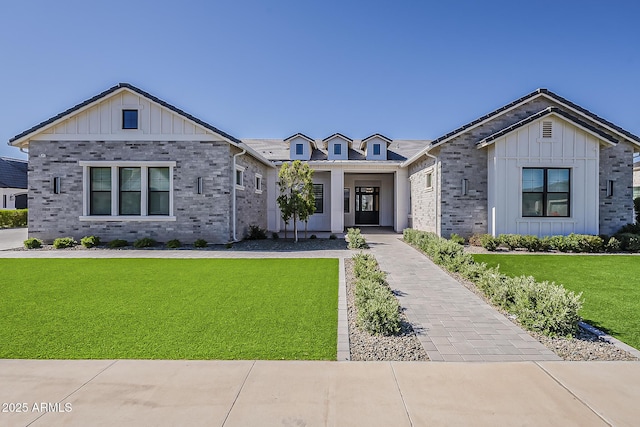 view of front of property featuring a front lawn and board and batten siding