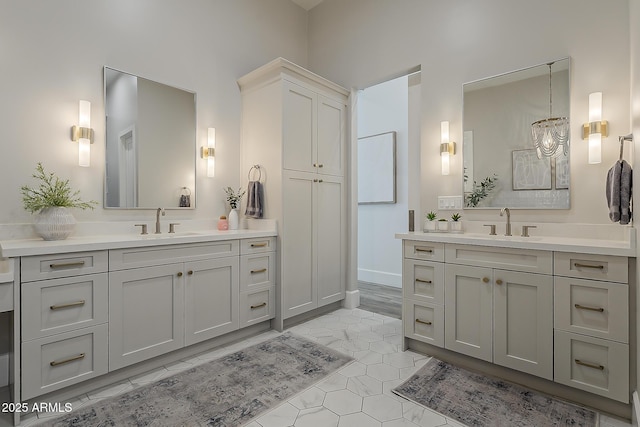 bathroom with a sink, tile patterned floors, and two vanities