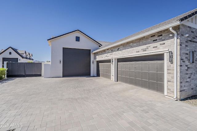 garage with decorative driveway